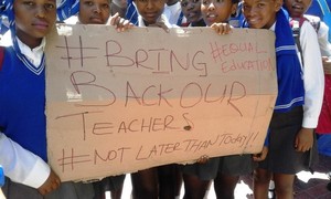 Photo of students with placard