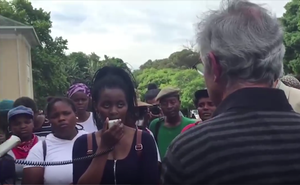 Photo of protesters addressing Max Price