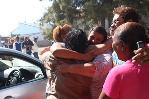 Photo of parents and teachers hugging