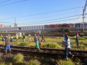 Photo of people walking on railway lines