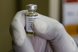 A nurse uses a syringe to draw Lenacapavir, an antiretroviral HIV prevention drug from a vial during a roll out of the drug as part of an implementation study by a Wits University research unit.