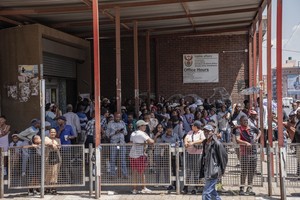 People are seen outside the Johannesburg Local Office of Home Affairs in the Johannesburg CBD.