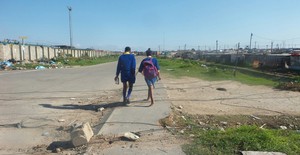 Photo of children stepping over exposed electricity cables