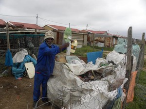 Photo of a man with big bales of plastic