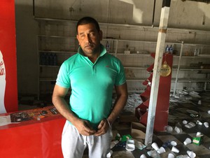 Photo of man in ruins of shop