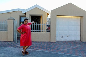 Photo of a woman outside her house