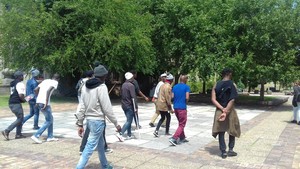 Photo of men carrying sticks