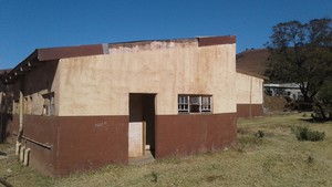 Photo of building with people's beds on the lawn