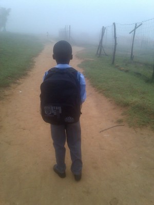 Photo of child in school uniform.