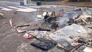 Photo of burnt stove and debris