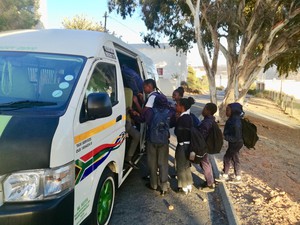 Photo of school kids getting into a taxi